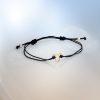 18ct Fairmined gold jaguar head charm on adjustable black macrame bracelet