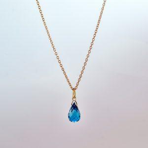 Faceted London blue topaz briolette pendant on 18ct yellow Fairtrade gold chain.