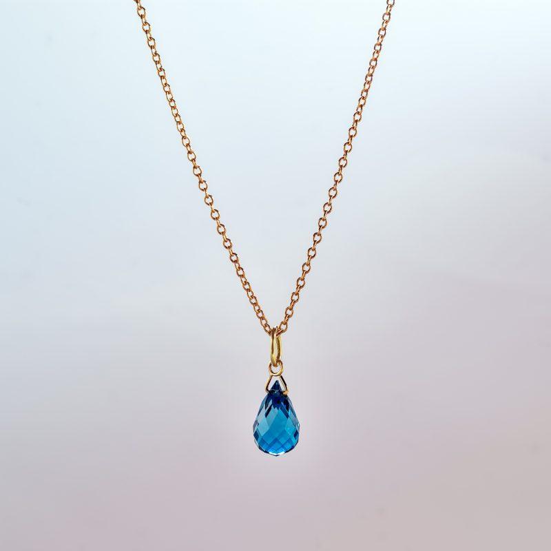 Faceted London blue topaz briolette pendant on 18ct yellow Fairtrade gold chain.