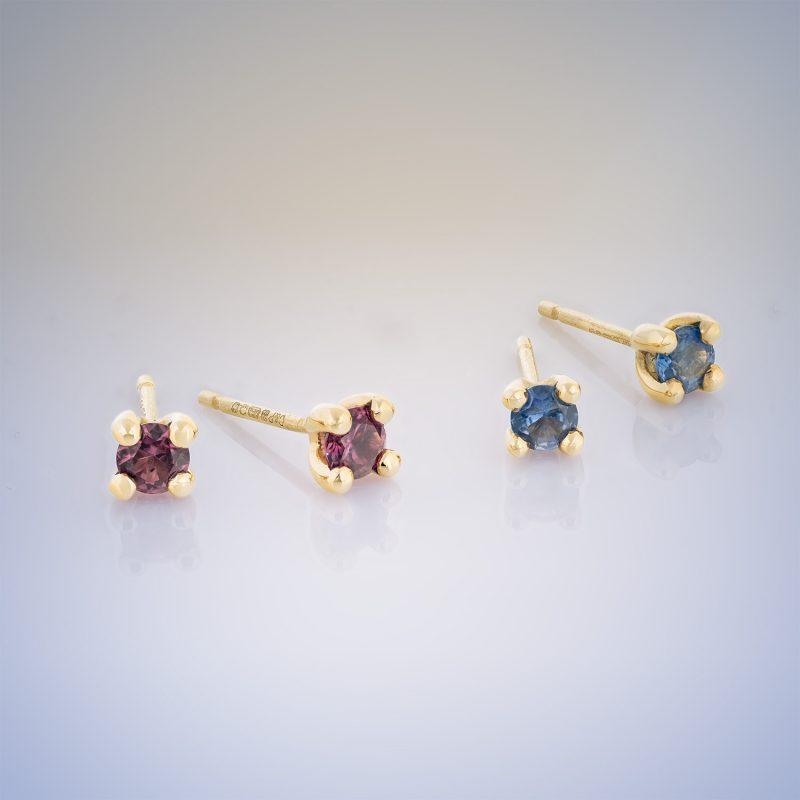 two pairs of 18ct yellow gold stud earrings with claw-set gemstones - red ruby and blue sapphire
