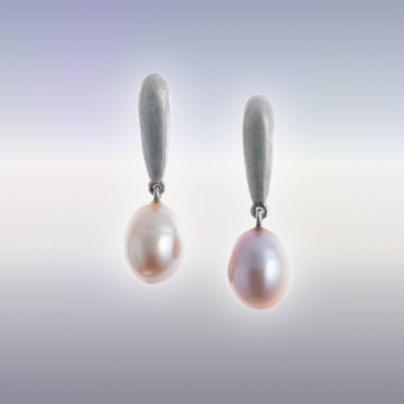 A pair of silver earrings with oval peach-pink coloured natural pearl drops